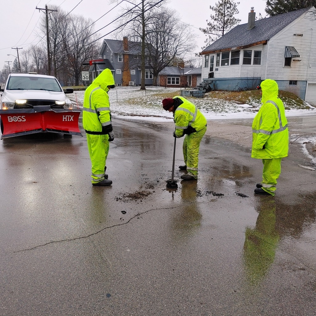 water plant workers cleaning up a road