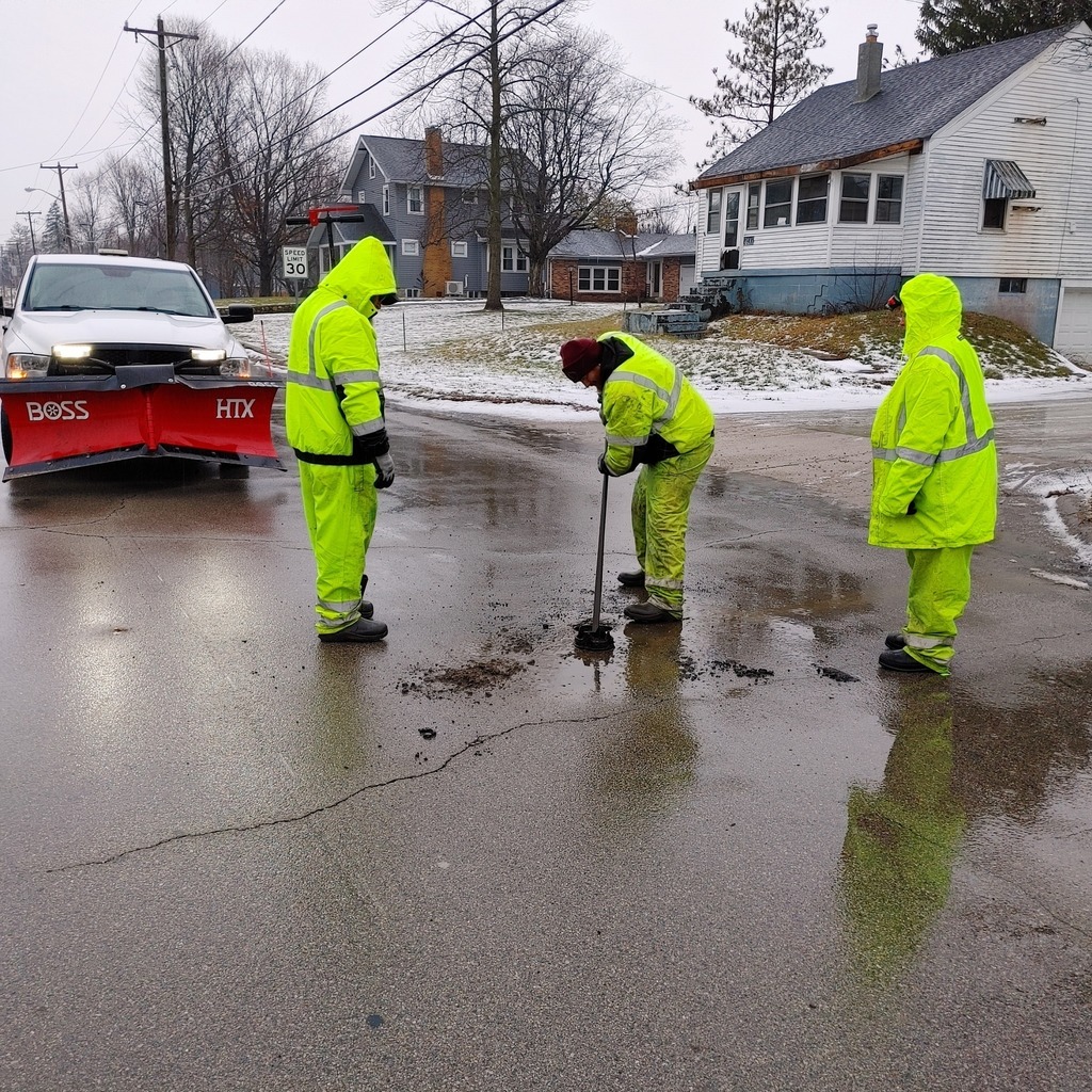 water plant workers cleaning up a road