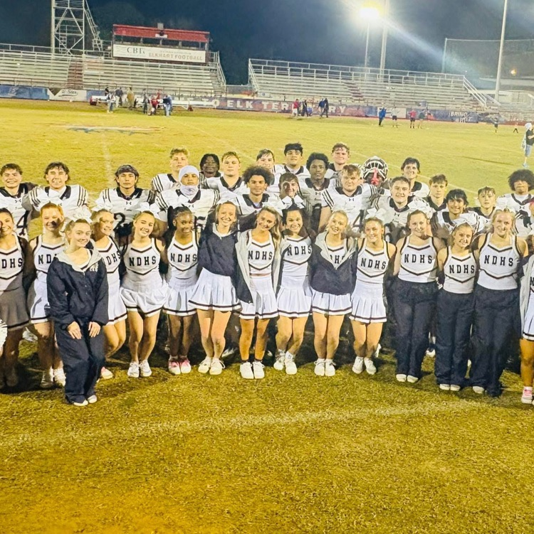 photo of football team and cheerleaders