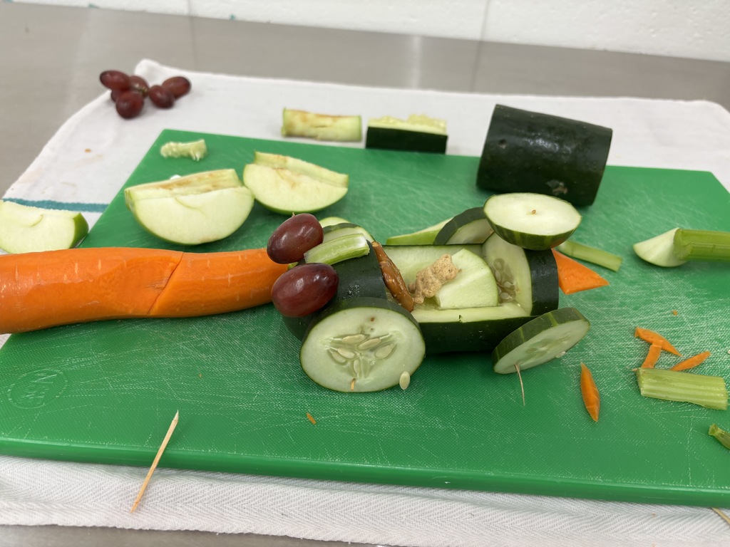 Wow! Mrs. Schmitt is so impressed by her Day One 7th Graders FCS students! They practiced knife skills today by cutting fruit and vegetables to make their individual cars. In a previous class they drew out their sketches and made a plan and a list of what they needed. Take a look at the pictures to see their success! 