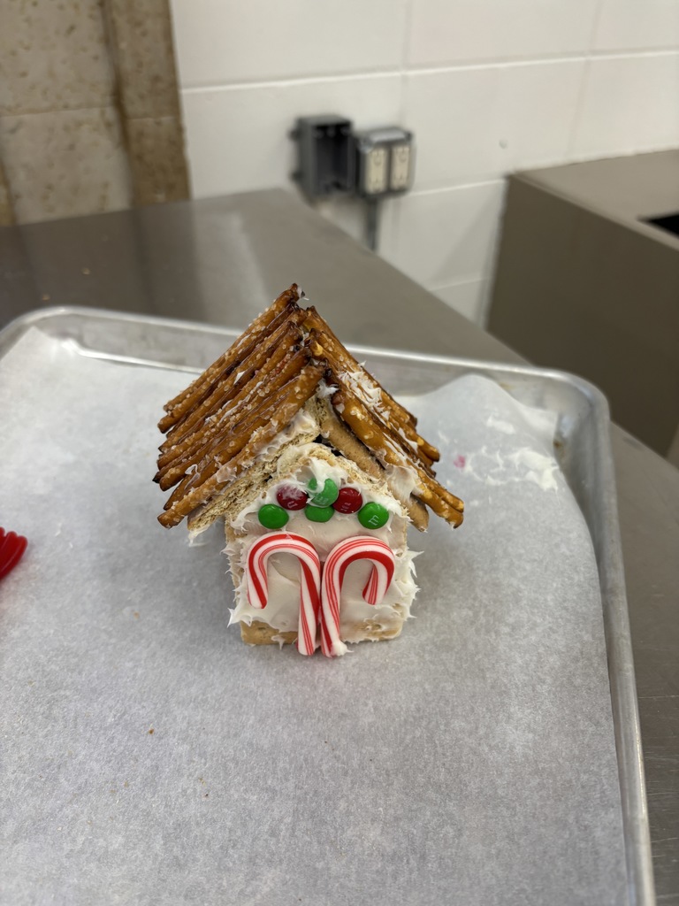 7th Grade FCS constructed "gingerbread" houses out of graham crackers in FCS class. Some imploded and were not successful. Please Vote ONLY by liking the picture. You have five to choose from. Thanks! 