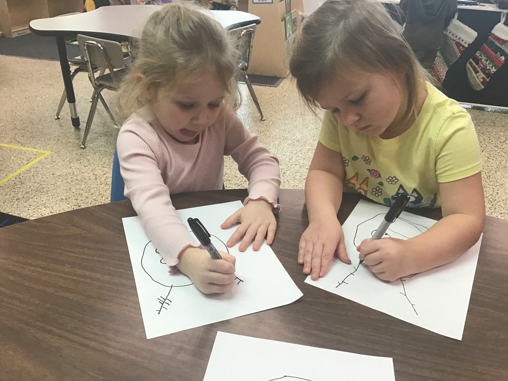 These three year olds have been busy in December! The students sorted in the sensory table with magnetic wands, jingle bells, tinsel, and pompoms. They played with their peers in the dramatic play center with a hot cocoa stand, Christmas baking, and a tree to decorate. In the writing center, the students wrote letters to Santa and  put them in the mailbox to send them to the North Pole. In art, the preschoolers painted with pine boughs and created their own reindeer directed drawing. So many engaging ways to learn and play with friends!