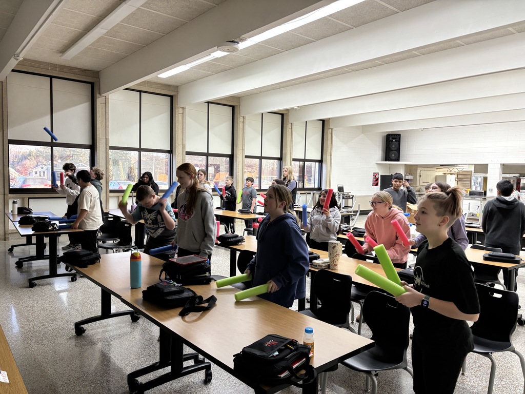 Being healthy is more than just eating nutritious food. The 7th grade FCS class enjoyed doing "Cardio Desk Drumming" with pool noodles and some rock'in music videos from a P.E. teacher. Also the students were laughing and having fun. Another important part to a healthy lifestyle. (the lights were off, so the pictures are a little dark.)