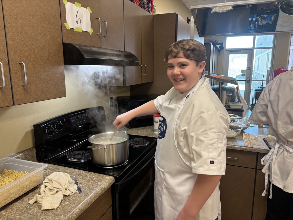 Wow! What an amazing experience for our 7th grade students. Mrs. Schmitt's 7th grade FCS was invited to Waverly-Shell Rock's Middle School Friday, February 13th for an all-day event, along with other schools. Students: Ellie Carlson, Beau Johnson, Dempsey Nelson, and Adam Scott. Mrs. April Schmitt and student teacher, Miss Whitney Tegtmeier accompanied the group too. Kids Feeding Kids is a program that helps with food insecurities. Students made meals that can be frozen and handed out to families. The students made 61 meals. The students learned from a professional chef how to Mise En Place, Knife Skills, time management, how to follow directions, and prep ingredients. The students started with a scavenger hunt on finding the equipment needed to make macaroni and cheese (with Great Northern Beans for protein) topped with Panko bread crumbs, cheese, and parsley. You will see from the pictures how hard the students worked. New Hampton Middle School was awarded "Most Organized" out of the six schools that attended. A huge "thank you" to Kristie Kuhse and Waverly Shell-Rock for this opportunity.