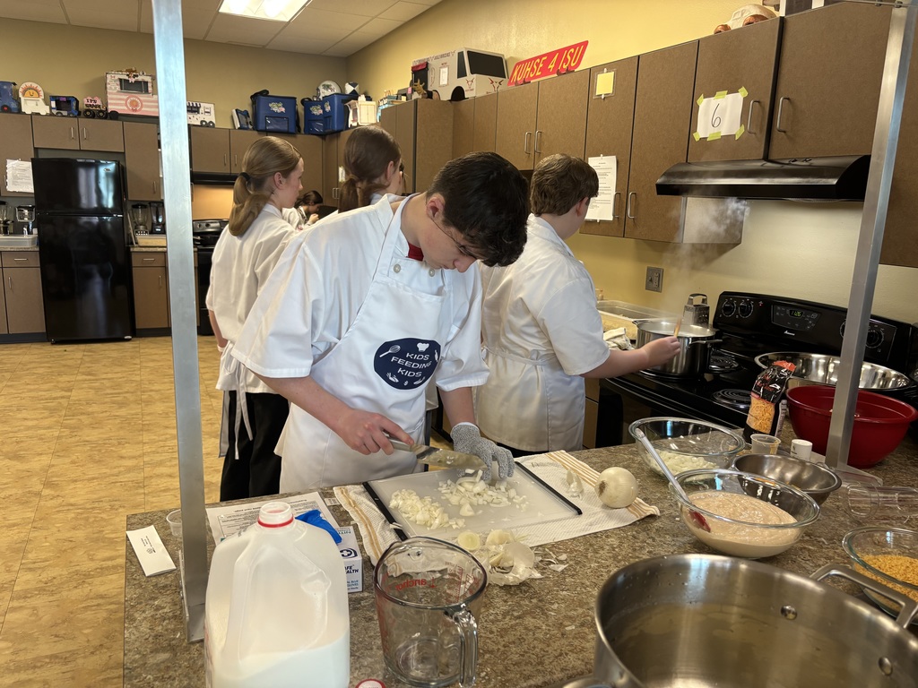 Wow! What an amazing experience for our 7th grade students. Mrs. Schmitt's 7th grade FCS was invited to Waverly-Shell Rock's Middle School Friday, February 13th for an all-day event, along with other schools. Students: Ellie Carlson, Beau Johnson, Dempsey Nelson, and Adam Scott. Mrs. April Schmitt and student teacher, Miss Whitney Tegtmeier accompanied the group too. Kids Feeding Kids is a program that helps with food insecurities. Students made meals that can be frozen and handed out to families. The students made 61 meals. The students learned from a professional chef how to Mise En Place, Knife Skills, time management, how to follow directions, and prep ingredients. The students started with a scavenger hunt on finding the equipment needed to make macaroni and cheese (with Great Northern Beans for protein) topped with Panko bread crumbs, cheese, and parsley. You will see from the pictures how hard the students worked. New Hampton Middle School was awarded "Most Organized" out of the six schools that attended. A huge "thank you" to Kristie Kuhse and Waverly Shell-Rock for this opportunity.