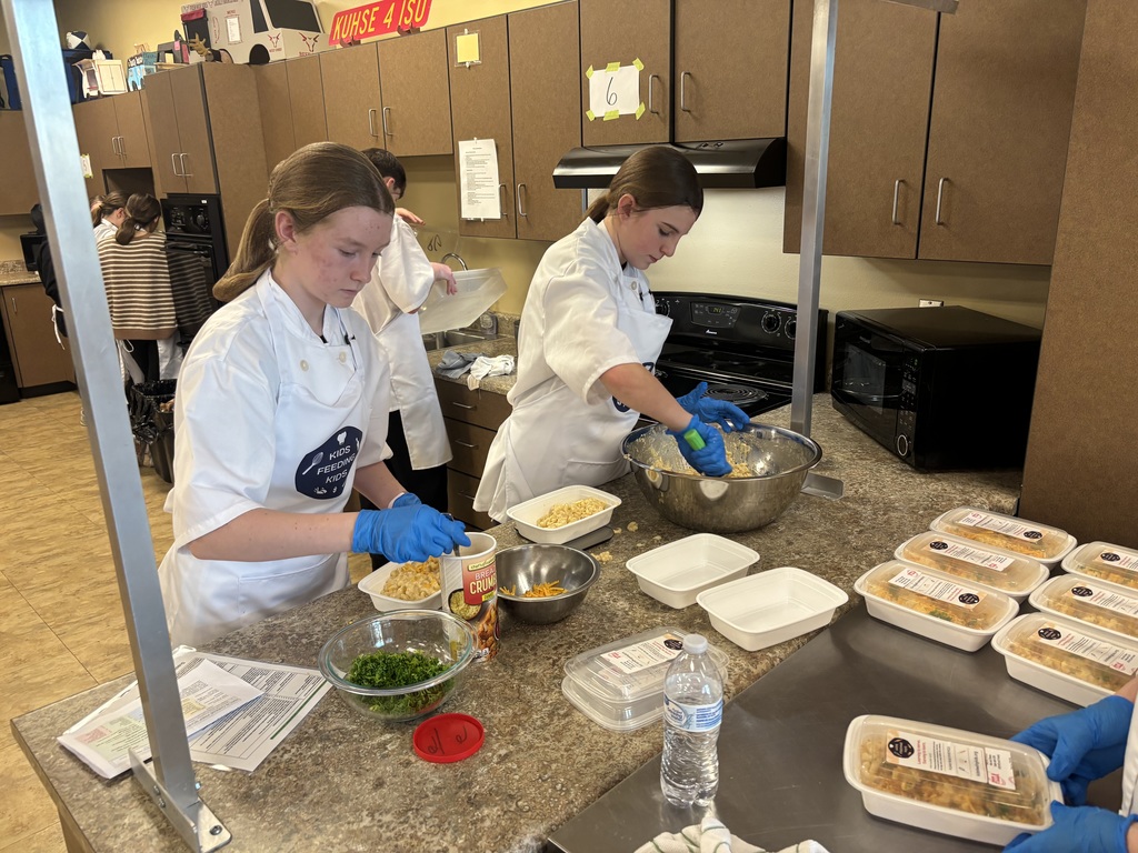 Wow! What an amazing experience for our 7th grade students. Mrs. Schmitt's 7th grade FCS was invited to Waverly-Shell Rock's Middle School Friday, February 13th for an all-day event, along with other schools. Students: Ellie Carlson, Beau Johnson, Dempsey Nelson, and Adam Scott. Mrs. April Schmitt and student teacher, Miss Whitney Tegtmeier accompanied the group too. Kids Feeding Kids is a program that helps with food insecurities. Students made meals that can be frozen and handed out to families. The students made 61 meals. The students learned from a professional chef how to Mise En Place, Knife Skills, time management, how to follow directions, and prep ingredients. The students started with a scavenger hunt on finding the equipment needed to make macaroni and cheese (with Great Northern Beans for protein) topped with Panko bread crumbs, cheese, and parsley. You will see from the pictures how hard the students worked. New Hampton Middle School was awarded "Most Organized" out of the six schools that attended. A huge "thank you" to Kristie Kuhse and Waverly Shell-Rock for this opportunity.