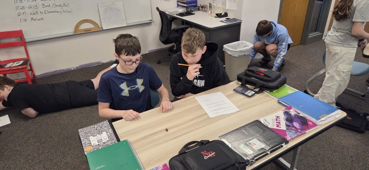 7th graders conducting experiments to compare experimental and theoretical probability in Mr. Erlandson's math class.