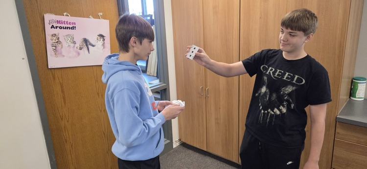 7th graders conducting experiments to compare experimental and theoretical probability in Mr. Erlandson's math class.