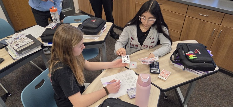 7th graders conducting experiments to compare experimental and theoretical probability in Mr. Erlandson's math class.