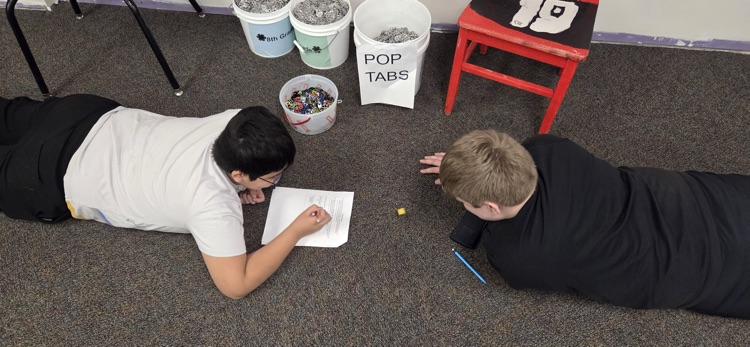 7th graders conducting experiments to compare experimental and theoretical probability in Mr. Erlandson's math class.