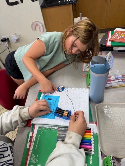 4th graders got the chance to bring working with circuits. Students have been learning about the different types of energy. Yesterday, they had the chance to start working with circuits. They had to make a closed circuit with 1 battery, 2 wires, and a light bulb!
