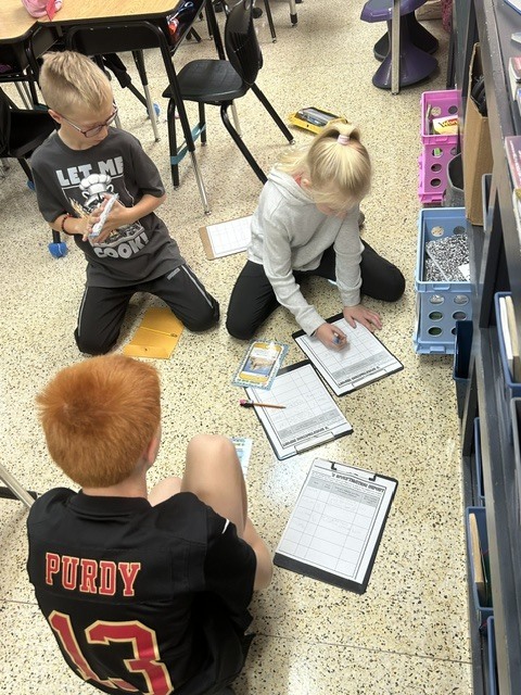 The 4th graders have been putting their inference skills to the test in literacy! Students read clues, used their background knowledge, and made inferences to figure out where a person lives and what costume they are wearing for Halloween. 🏡🦇   They had to look beyond what the clues said and use their detective skills to figure out what they could infer! 🔎🧠   The students are learning that good readers don’t just read the words—they think about the clues and put the pieces together! 📚✨   #FourthGradeLiteracy #MakingInferences #ReadingDetectives #LearningIsFun