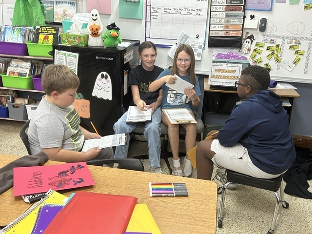 The 4th graders have been putting their inference skills to the test in literacy! Students read clues, used their background knowledge, and made inferences to figure out where a person lives and what costume they are wearing for Halloween. 🏡🦇   They had to look beyond what the clues said and use their detective skills to figure out what they could infer! 🔎🧠   The students are learning that good readers don’t just read the words—they think about the clues and put the pieces together! 📚✨   #FourthGradeLiteracy #MakingInferences #ReadingDetectives #LearningIsFun