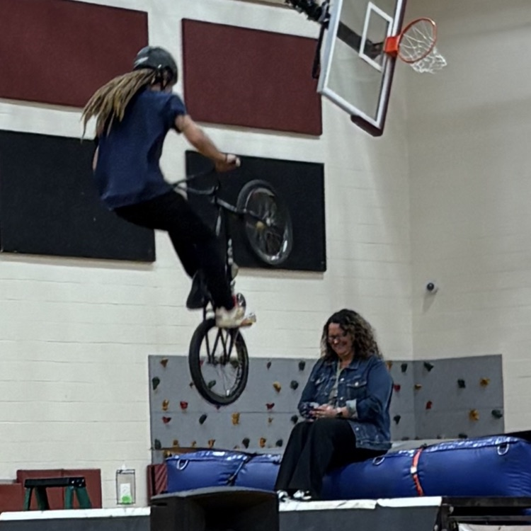 bike jumping over a staff member 
