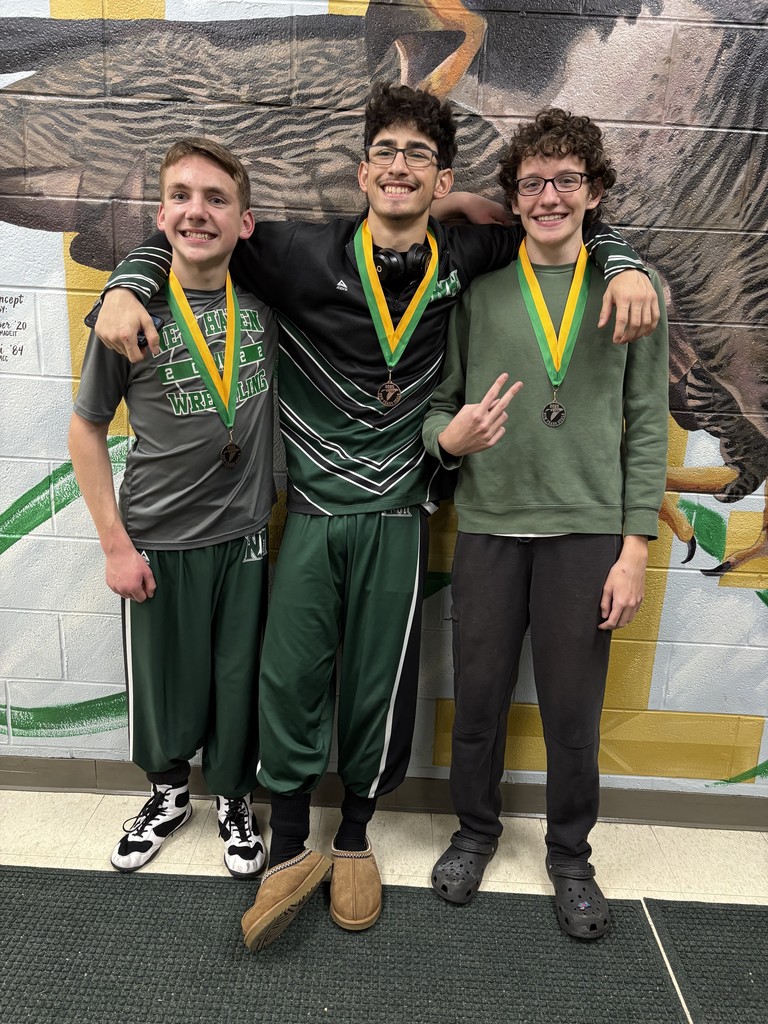 Three wrestlers with medals