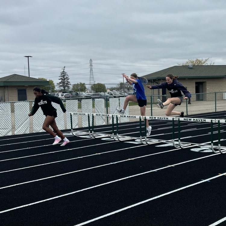 students jumping hurdles 
