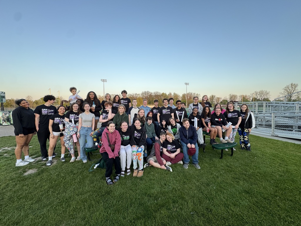 students posing for photo at sunset