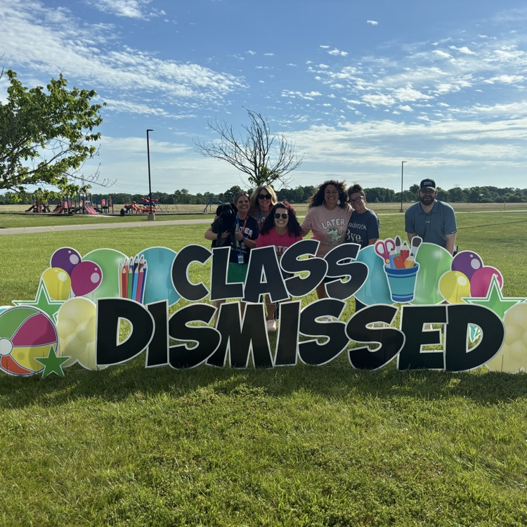 teachers by a sign