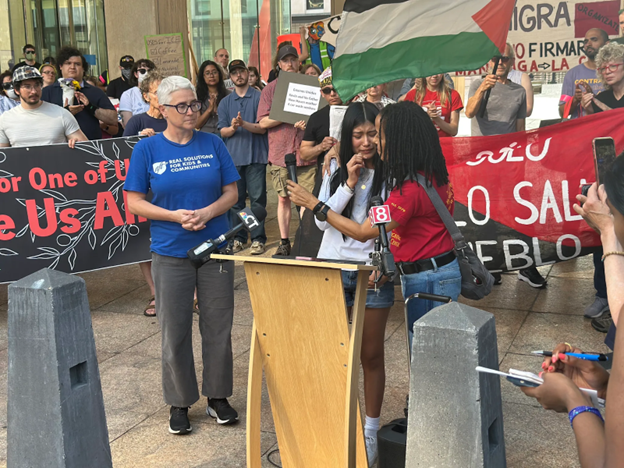 A photo depicting a teen crying about her mom’s deportation at a protest supporting Esdras Zabaleta-Ramirez.