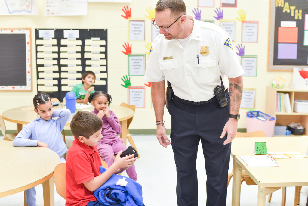 police officer showing a student the body cam