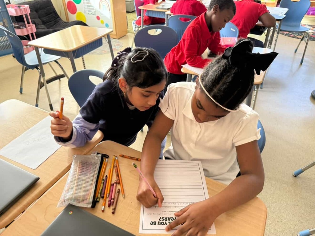 Students working on activities related to six and seven for the 67th Day of School