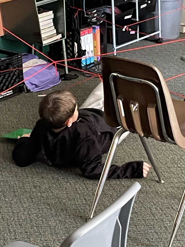 kid goes through fake laser grid