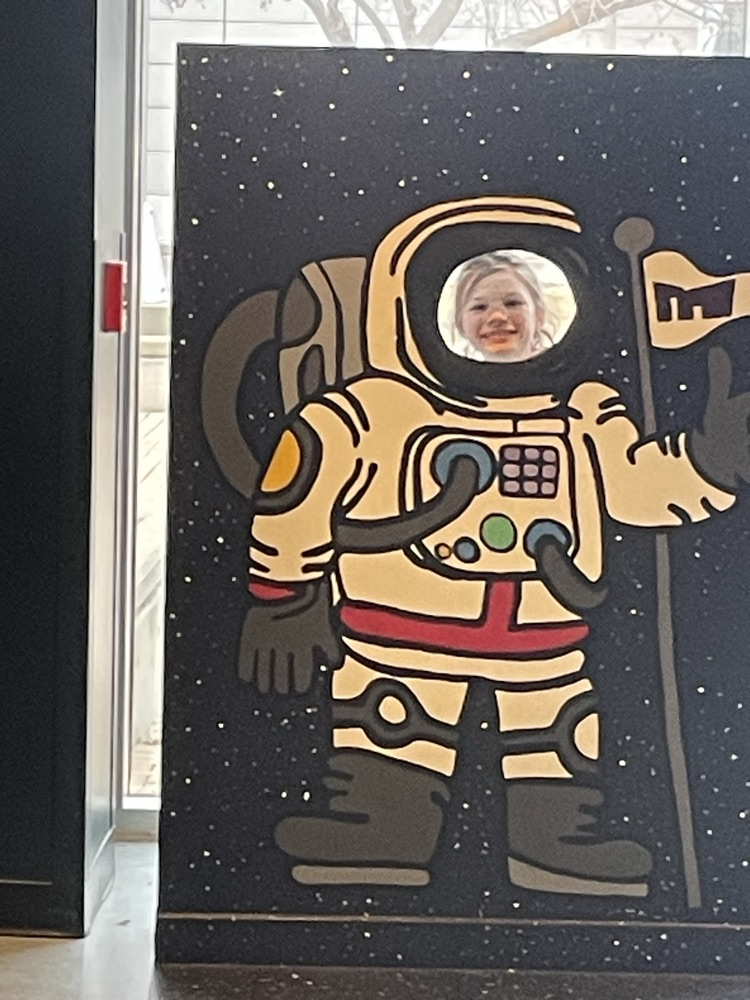 girl in an astronaut photo board