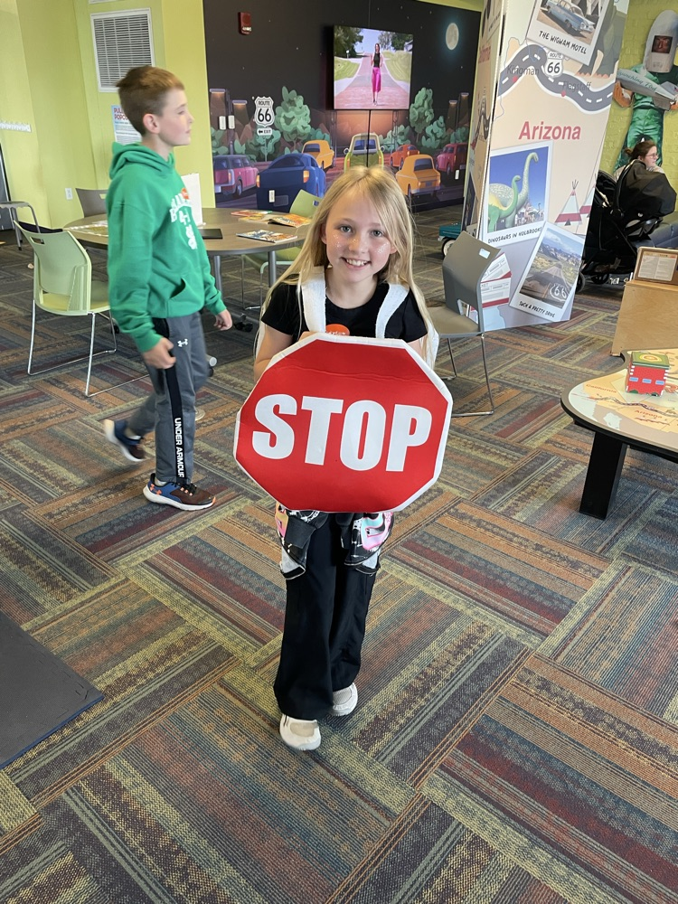 girl wearing stop sign