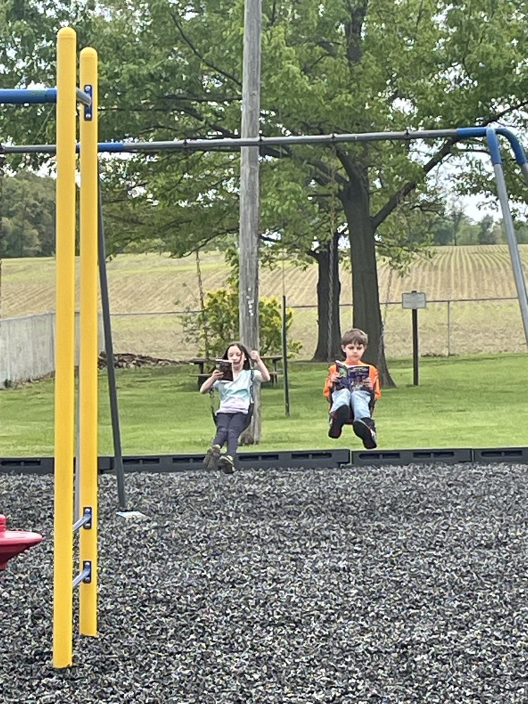 students reading on swings