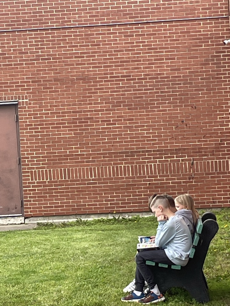 students reading on bench