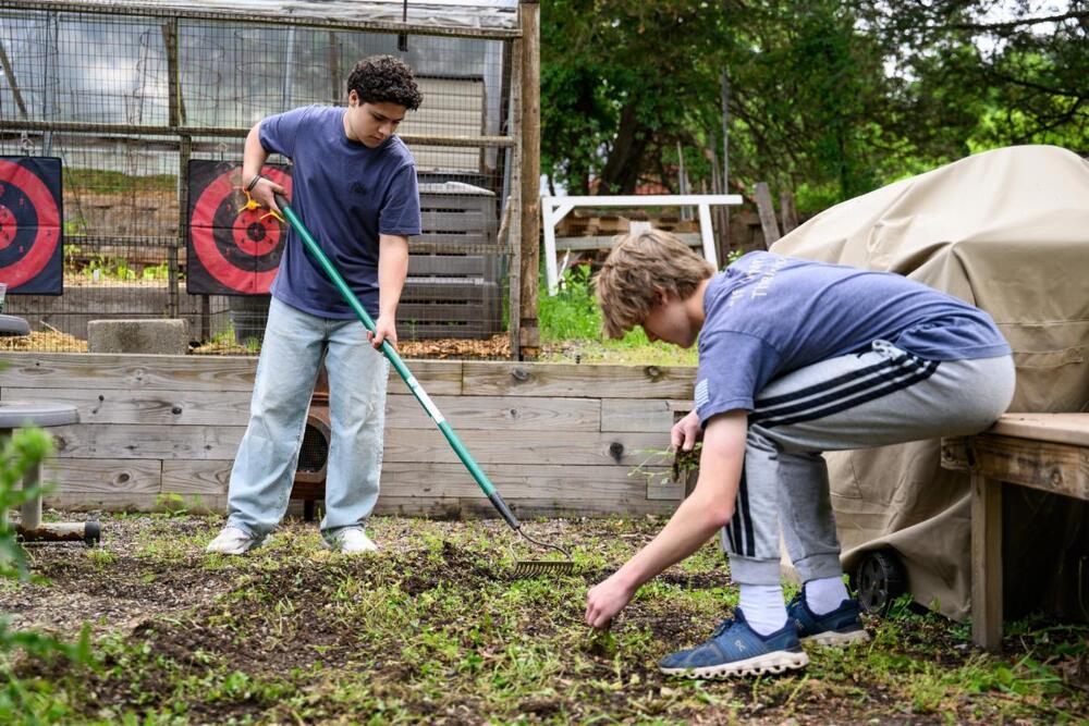 Middle School Students helping weed during the Day of Giving