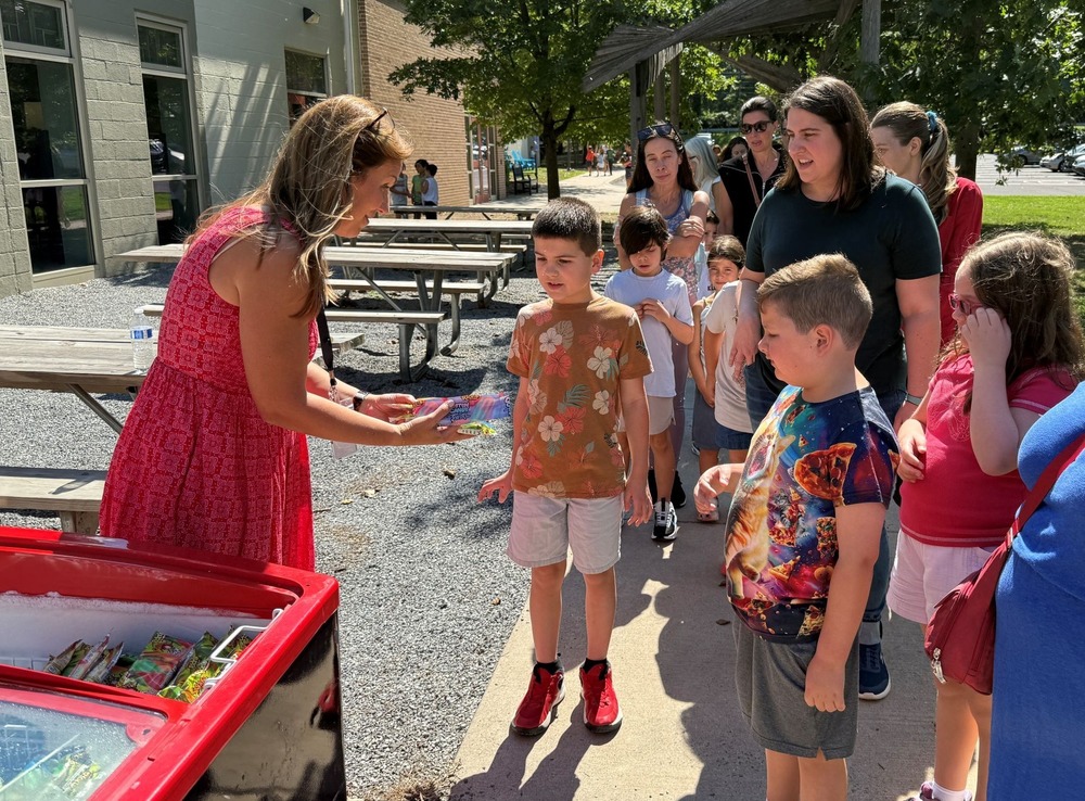 New principal greeting students on playground for Open House