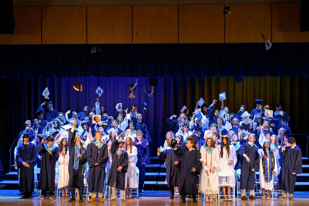 graduates throwing caps in the air