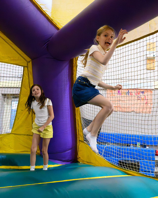 children jumping in bounce house