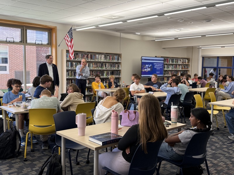 Group of students in library listening to speakers