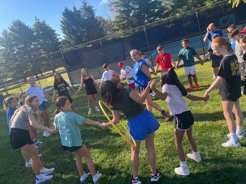6th graders holding hands at Camp America