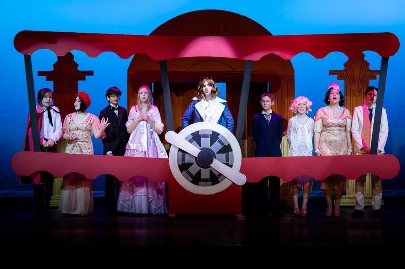 Middle Schoolstudents on stage performing Drowsy Chaperone Jr.