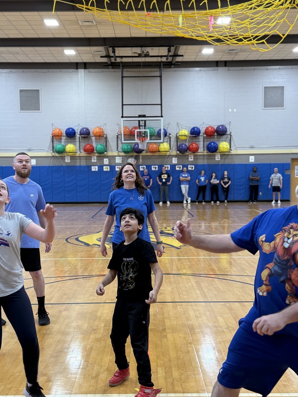 Boy and teachers looking up