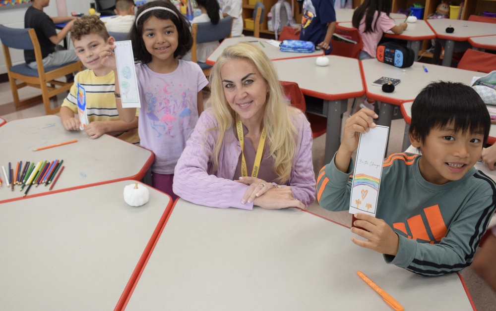 Students smiling with teacher.