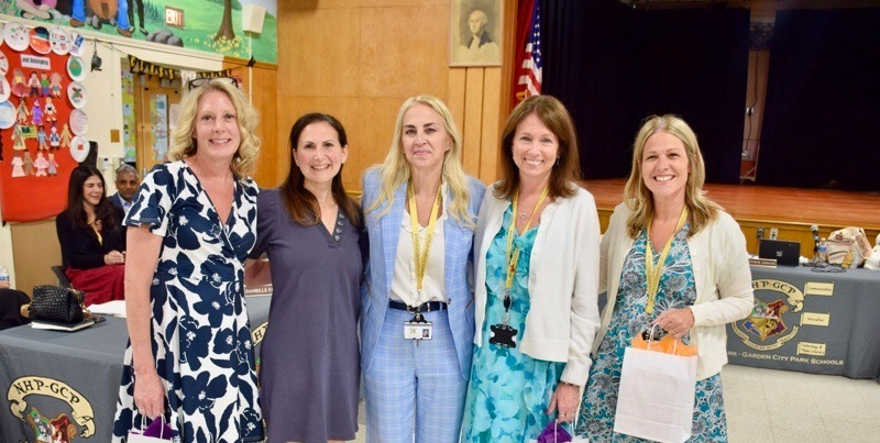 five women standing together indoors