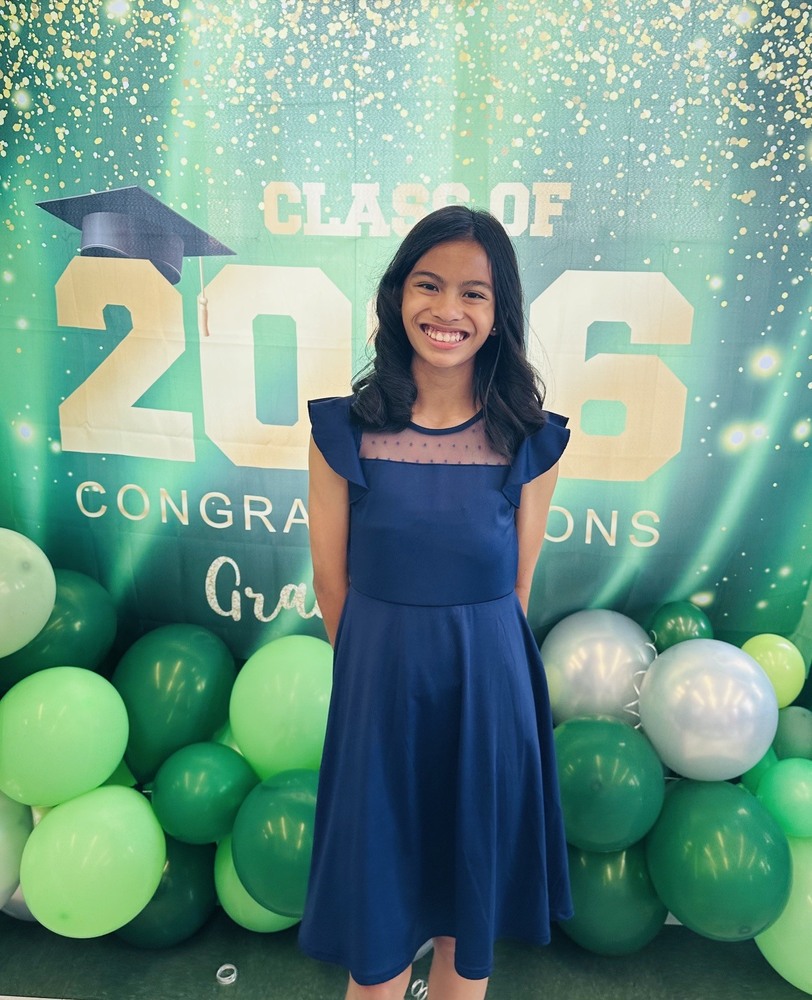 Student standing in front of Class of 2026 graphic.