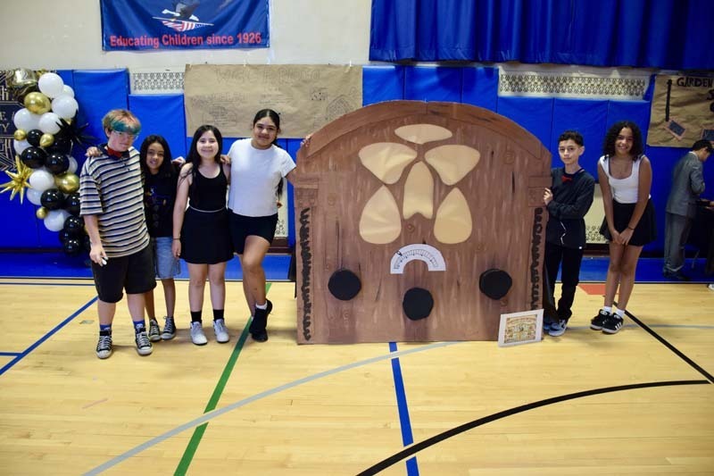 Students standing together in gymnasium.