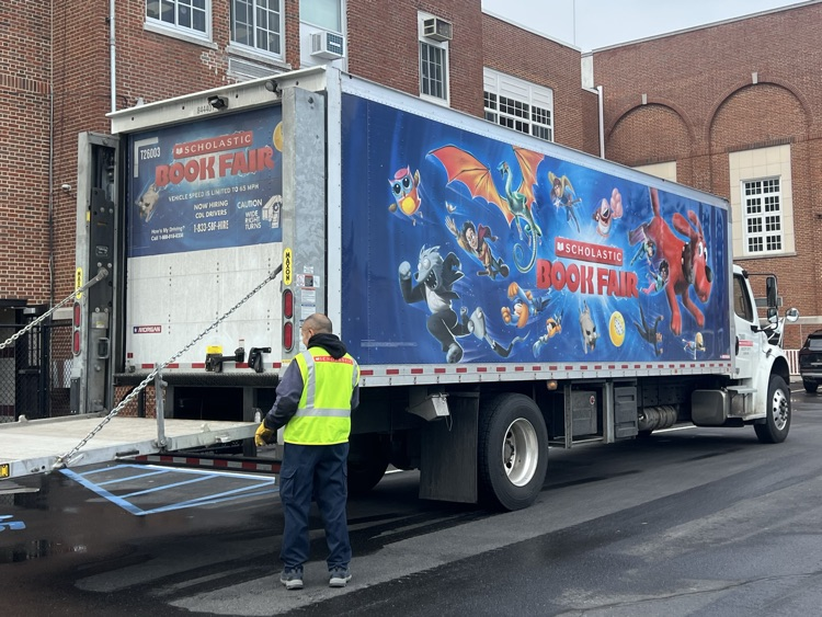 A truck in front of a school