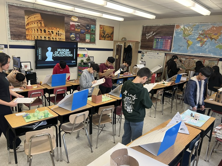 kids looking at projects on ancient Rome