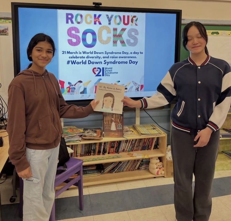 students holding a book