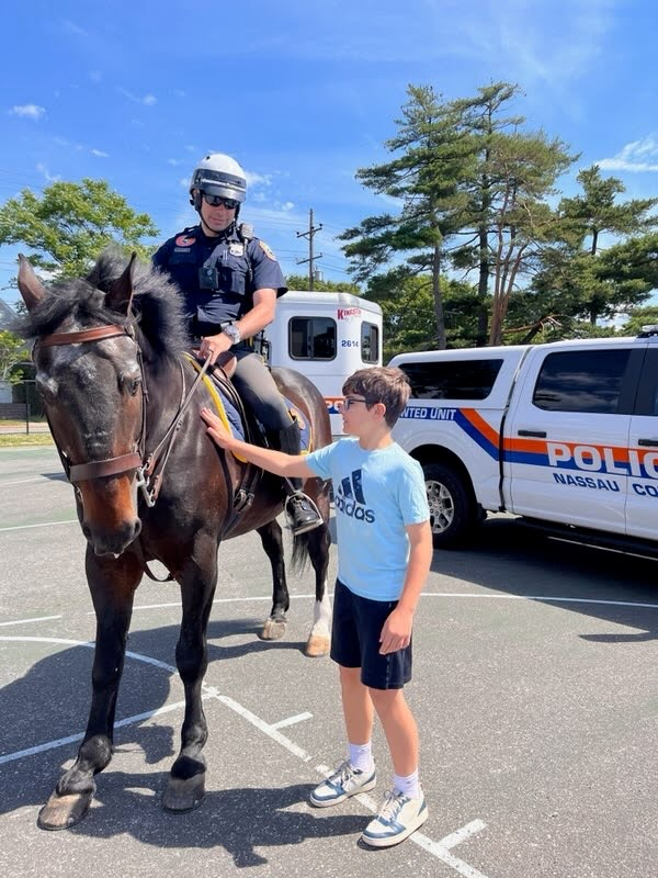 student touching a police horse