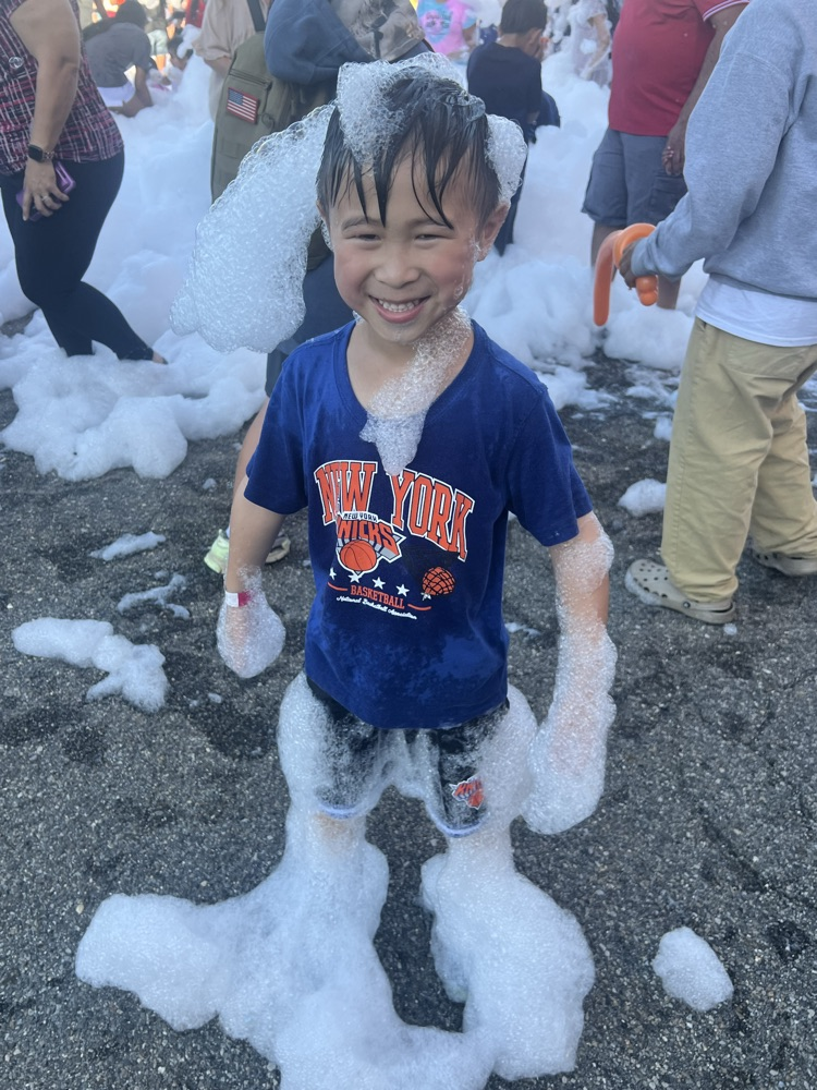 A boy covered in foam