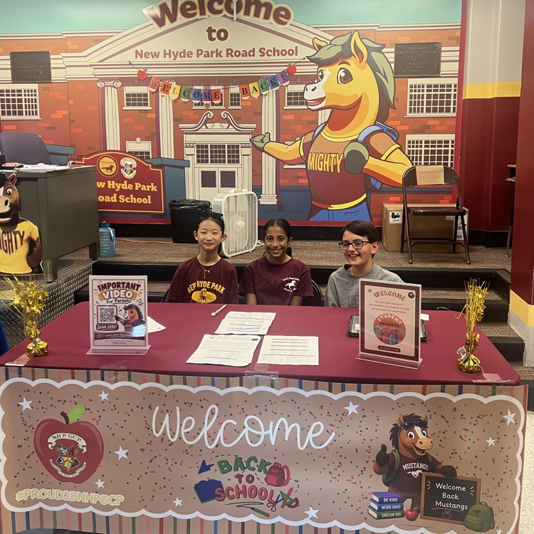 three students behind a table