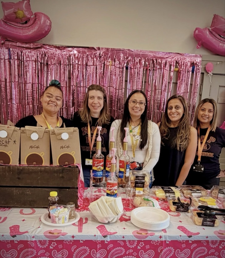 PTA member standing behind a table