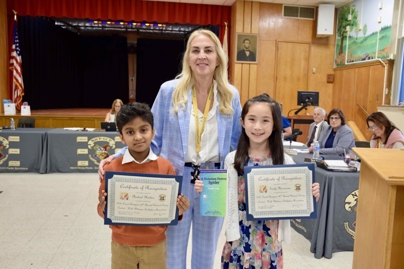 students holding certificates in classroom